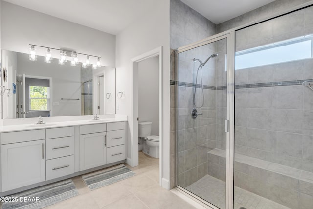 bathroom featuring walk in shower, tile patterned flooring, vanity, and toilet