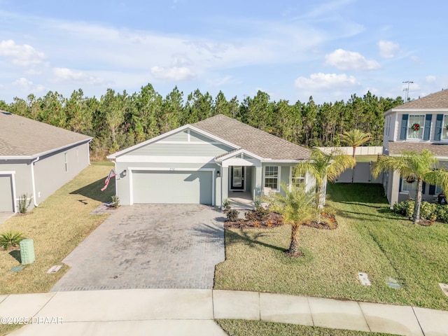 view of front of home featuring a front lawn and a garage