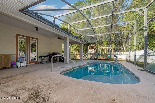 view of swimming pool featuring a fenced in pool, a ceiling fan, a patio area, a lanai, and fence