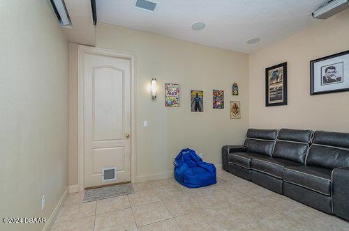living area featuring visible vents, baseboards, and light tile patterned floors