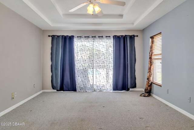 1001 Grassy Rdg, Port Orange, FL 32127 - empty room with a tray ceiling, carpet, ceiling fan, and baseboards