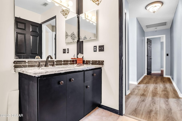 1001 Grassy Rdg, Port Orange, FL 32127 - bathroom featuring vanity, baseboards, and wood finished floors