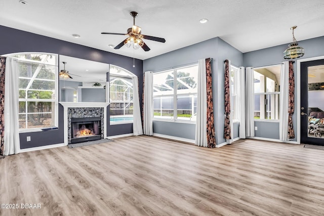 1001 Grassy Rdg, Port Orange, FL 32127 - unfurnished living room with ceiling fan, wood finished floors, baseboards, a textured ceiling, and recessed lighting