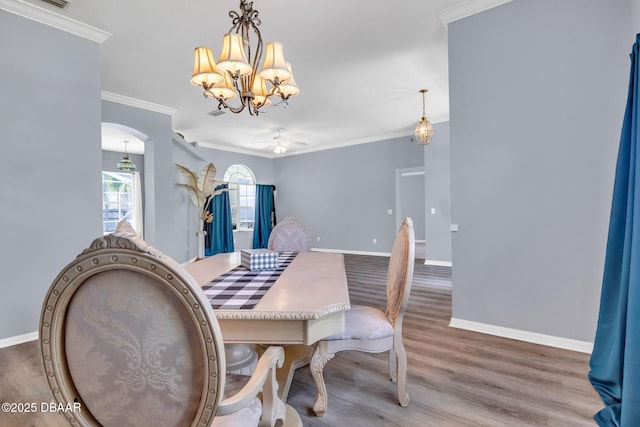 1001 Grassy Rdg, Port Orange, FL 32127 - dining area with a chandelier, ornamental molding, baseboards, and wood finished floors