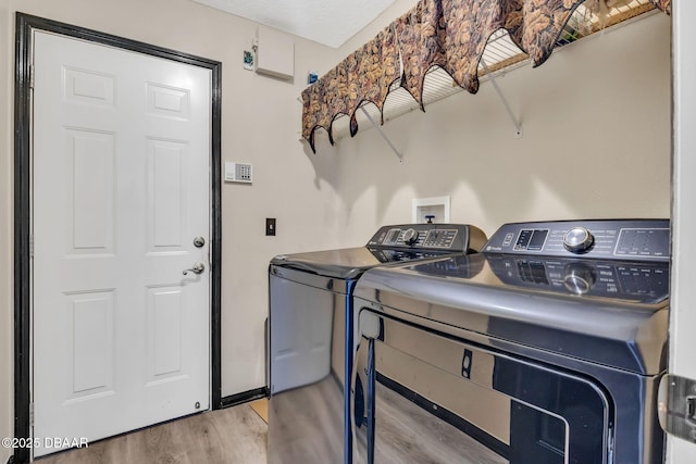 1001 Grassy Rdg, Port Orange, FL 32127 - laundry room featuring washing machine and dryer and wood finished floors