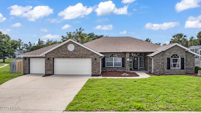 1001 Grassy Rdg, Port Orange, FL 32127 - view of front of home with an attached garage, brick siding, a front yard, and concrete driveway