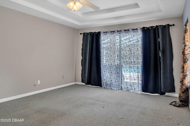 1001 Grassy Rdg, Port Orange, FL 32127 - carpeted spare room featuring a tray ceiling, a ceiling fan, and baseboards