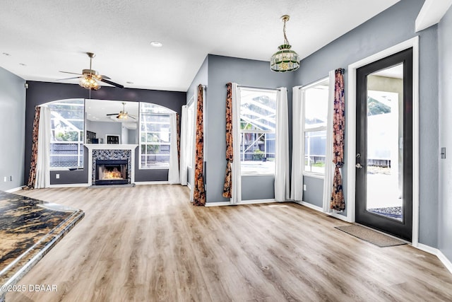 1001 Grassy Rdg, Port Orange, FL 32127 - foyer entrance with ceiling fan, wood finished floors, baseboards, a textured ceiling, and a warm lit fireplace
