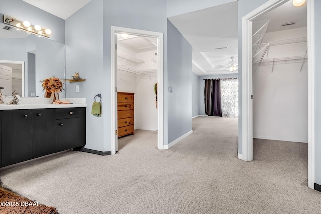 1001 Grassy Rdg, Port Orange, FL 32127 - bathroom featuring carpet, vanity, a ceiling fan, baseboards, and a spacious closet