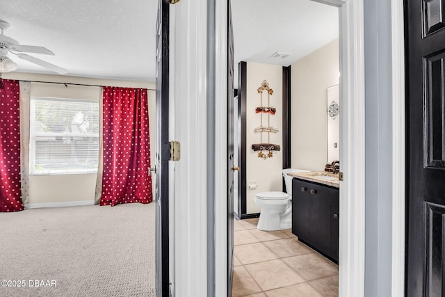 1001 Grassy Rdg, Port Orange, FL 32127 - bathroom featuring vanity, toilet, and a ceiling fan