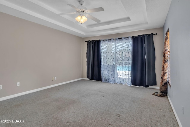 1001 Grassy Rdg, Port Orange, FL 32127 - carpeted spare room featuring a tray ceiling, a ceiling fan, and baseboards