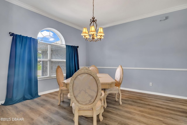 1001 Grassy Rdg, Port Orange, FL 32127 - dining space with a chandelier, crown molding, wood finished floors, and baseboards