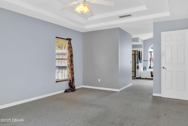 1001 Grassy Rdg, Port Orange, FL 32127 - empty room with a tray ceiling, carpet floors, a ceiling fan, and baseboards