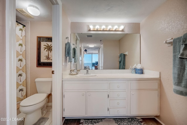 bathroom featuring hardwood / wood-style floors, ceiling fan, vanity, and toilet