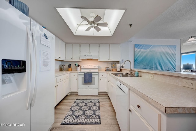 kitchen with sink, extractor fan, light wood-type flooring, white cabinetry, and white appliances