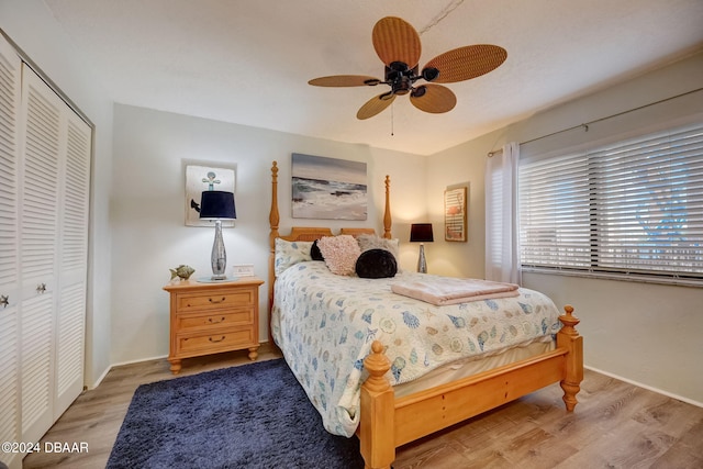 bedroom featuring hardwood / wood-style flooring, ceiling fan, and a closet