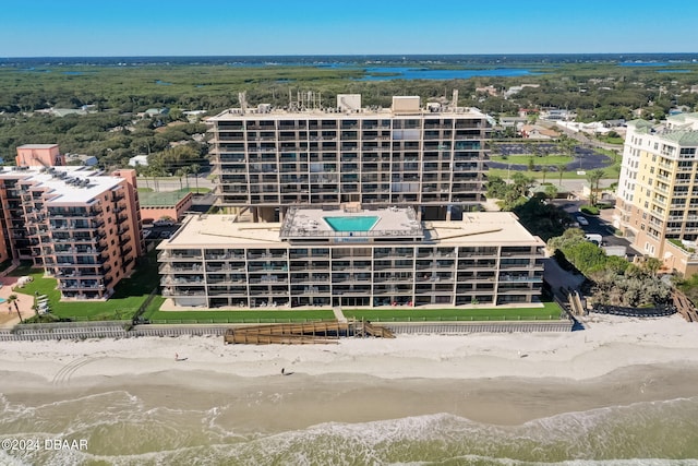 birds eye view of property with a water view and a view of the beach