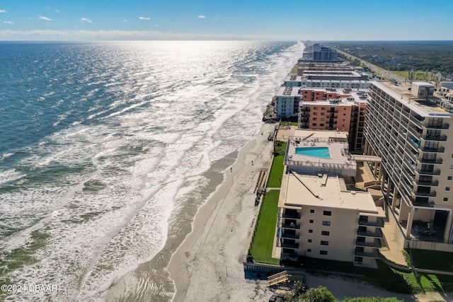 birds eye view of property with a beach view and a water view