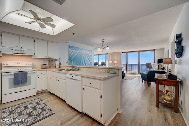 kitchen featuring white cabinetry, sink, white appliances, range hood, and light wood-type flooring