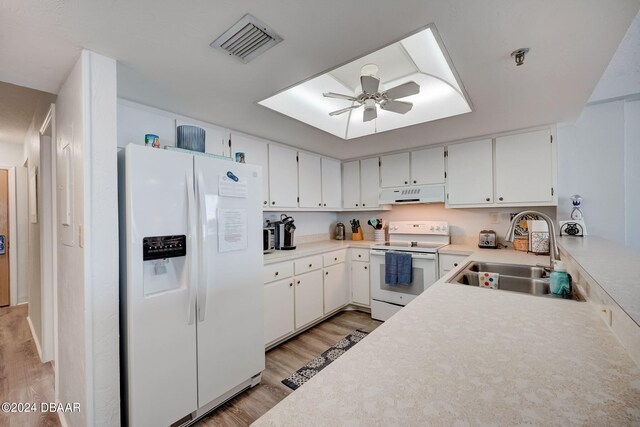 kitchen featuring white cabinetry, sink, ceiling fan, white appliances, and light wood-type flooring