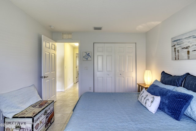 bedroom featuring a closet, visible vents, and light tile patterned flooring