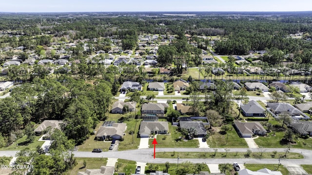 birds eye view of property featuring a view of trees and a residential view