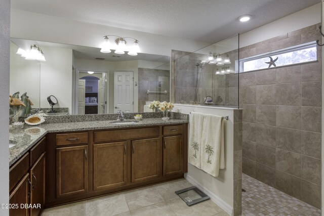 full bath featuring vanity, tile patterned flooring, ensuite bathroom, and walk in shower