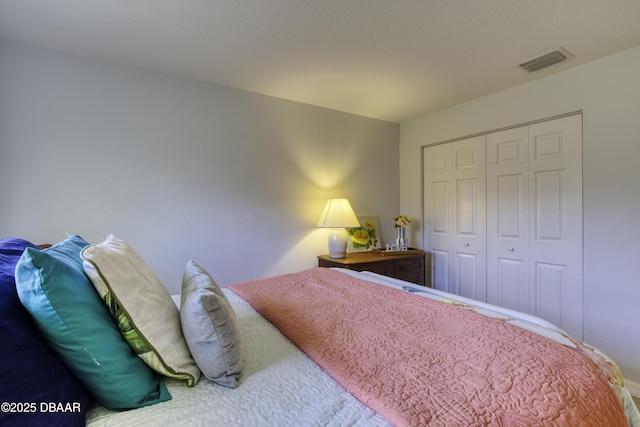 bedroom with a closet and visible vents