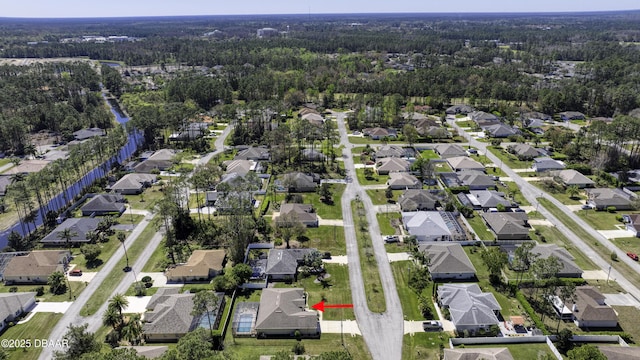 birds eye view of property featuring a residential view and a view of trees