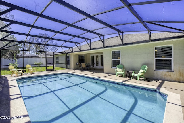 view of swimming pool with french doors, a patio, and a lanai