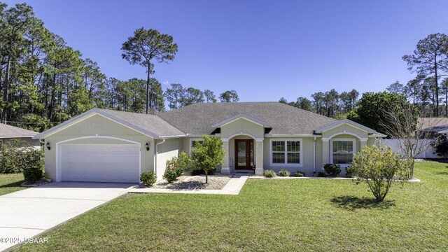 single story home featuring driveway, an attached garage, a shingled roof, stucco siding, and a front lawn