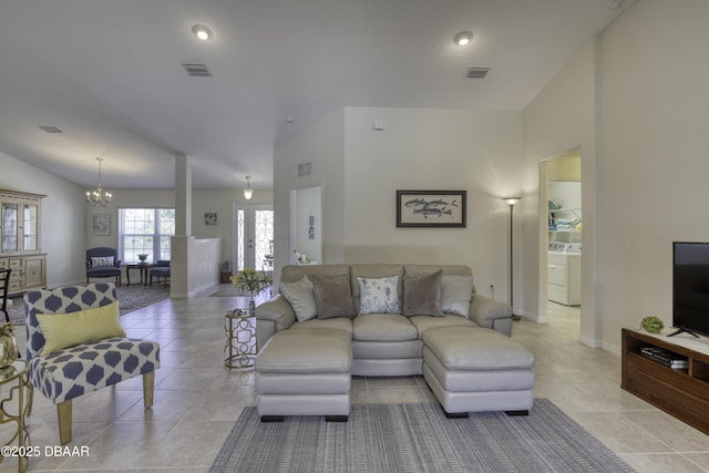 living area with washer / dryer, visible vents, and a chandelier