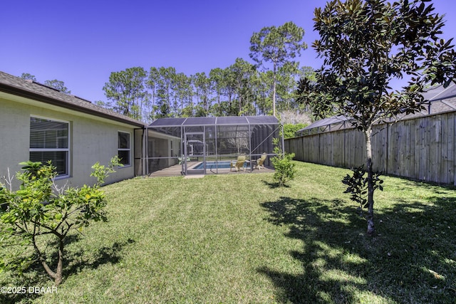 view of yard with glass enclosure, a fenced backyard, and a fenced in pool