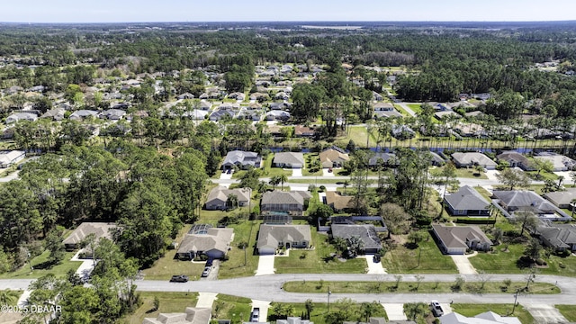 bird's eye view featuring a residential view and a wooded view