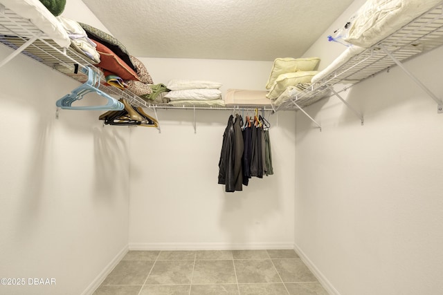 walk in closet featuring light tile patterned flooring