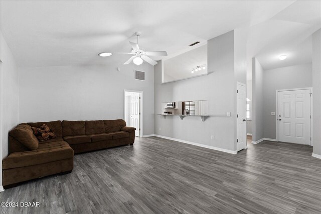 living room with high vaulted ceiling, dark wood-type flooring, and ceiling fan