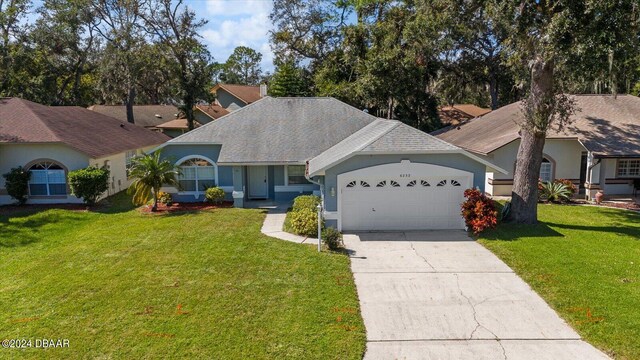 ranch-style house featuring a front lawn and a garage