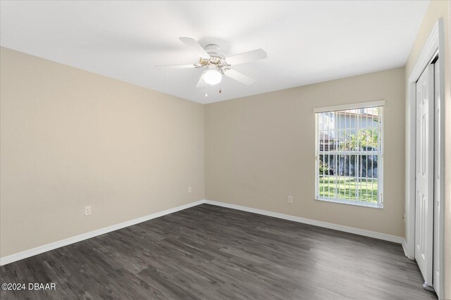 spare room featuring dark hardwood / wood-style flooring and ceiling fan