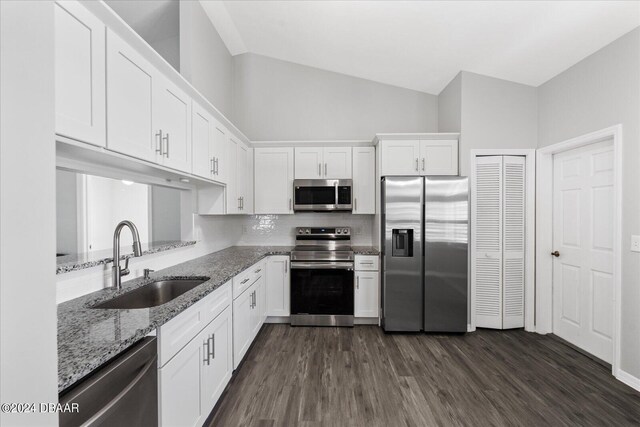 kitchen featuring white cabinets, stainless steel appliances, sink, and light stone counters