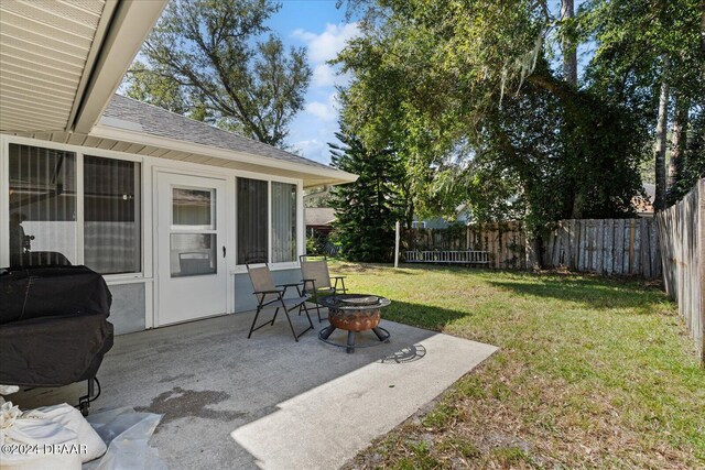 view of yard with an outdoor fire pit and a patio area