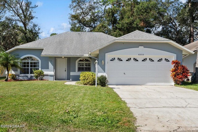 single story home with a garage and a front yard