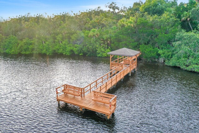 view of dock featuring a water view and a gazebo