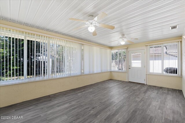 unfurnished sunroom featuring ceiling fan