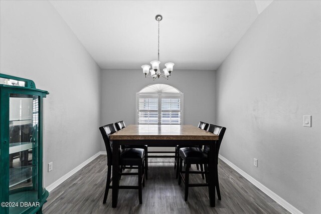 dining area featuring dark hardwood / wood-style floors and a notable chandelier