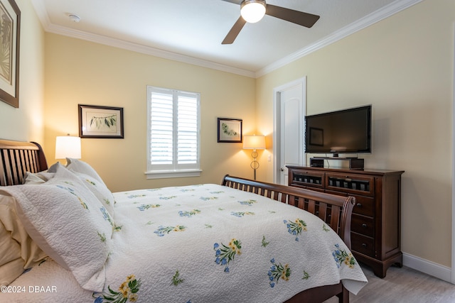 bedroom featuring ceiling fan, light hardwood / wood-style floors, and crown molding