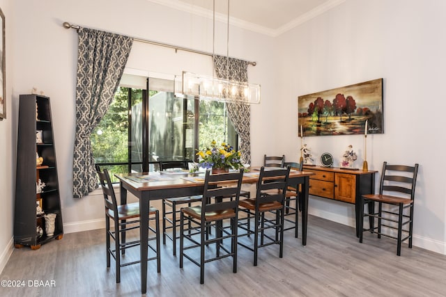 dining space featuring ornamental molding and hardwood / wood-style flooring