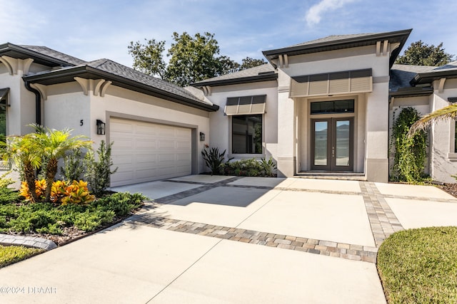 view of front of house with a garage and french doors