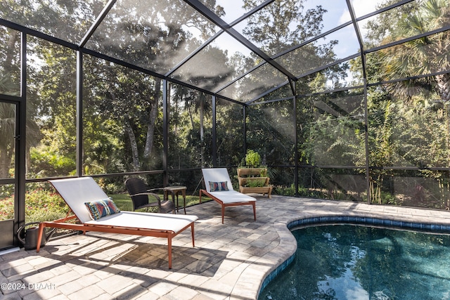 view of pool featuring a lanai and a patio