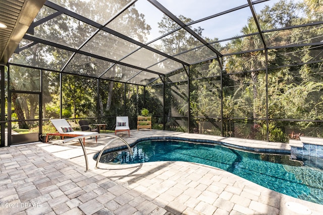 view of swimming pool with a lanai and a patio