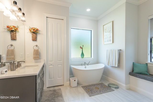 bathroom featuring a bath, vanity, and ornamental molding